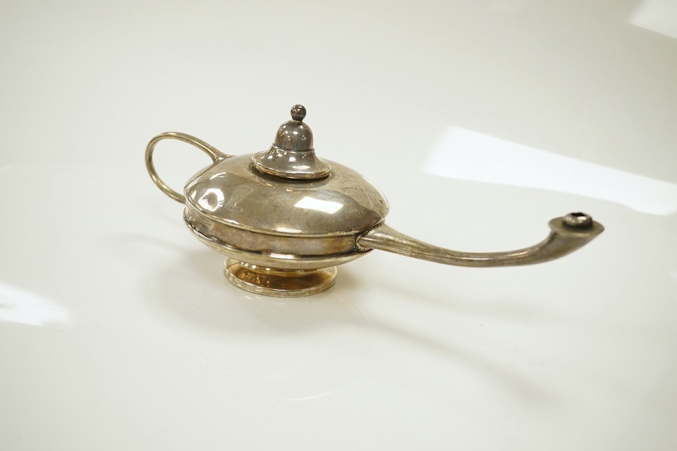 A group of assorted small silver comprising a George III helmet cream jug, a George V oil lamp cigar lighter, two stamp cases (6.5 oz), a white metal bowl stamped silver, an Indian white metal measuring cup, a small brus